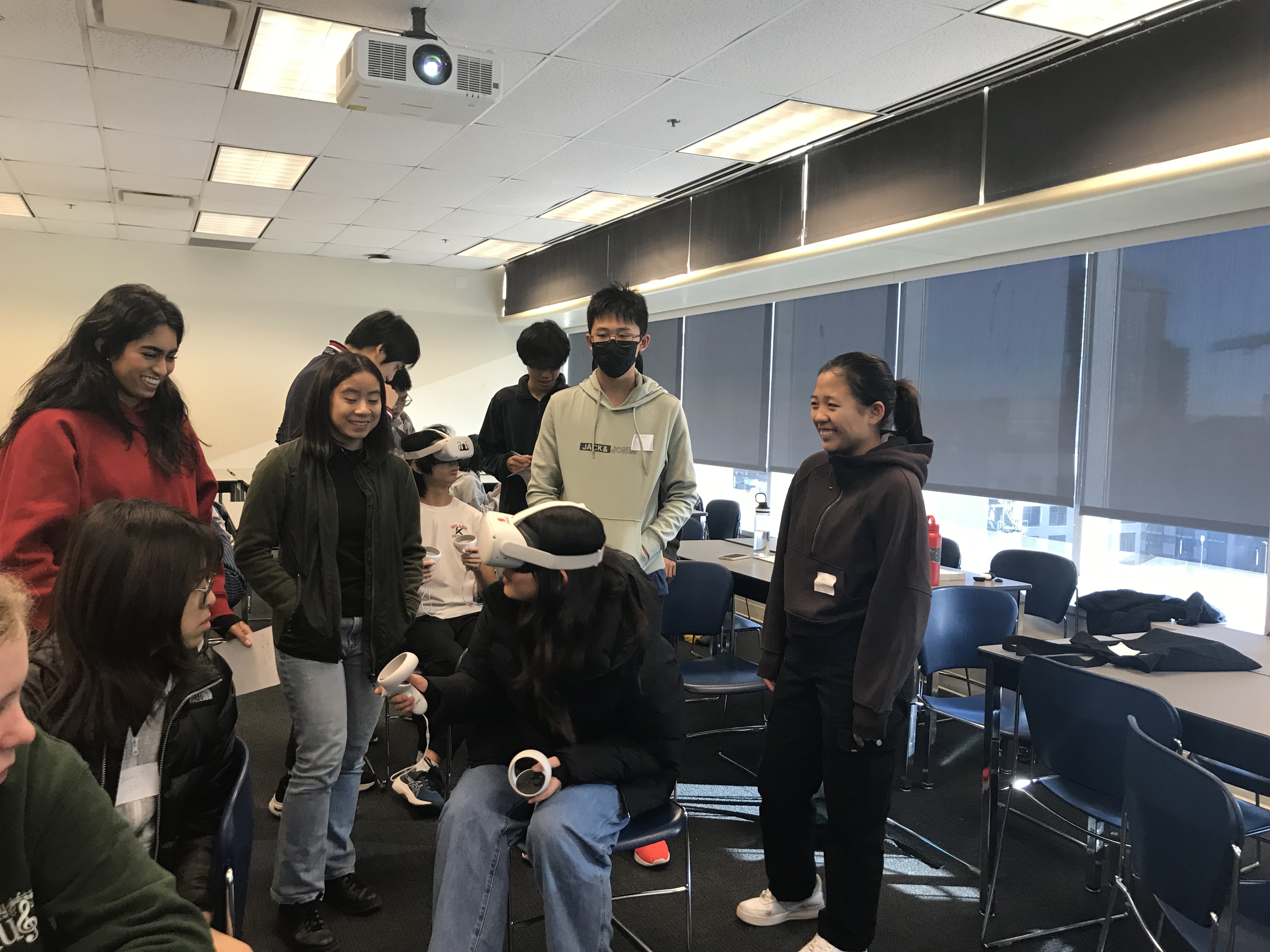 A presenter at STEMCon demonstrating a scientific experiment to an audience of students.
